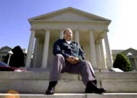 Man sitting in front of justice hall.