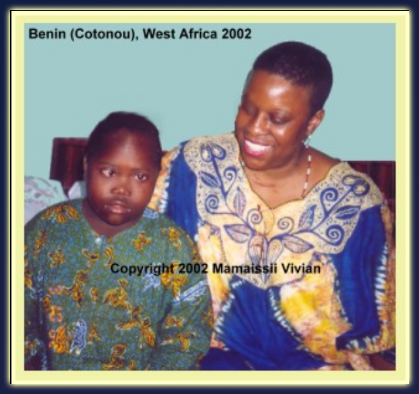 one person with disabilities next to Mama Zogbe who is smiling and enjoying their company